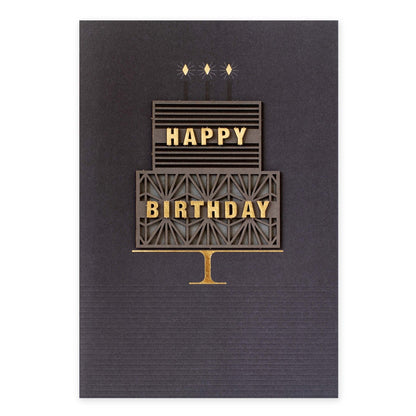 Hallmark Signature Birthday Card - Takes The Cake with layered 3D cake design and gold accents on dark background.