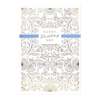 Hallmark Signature Wedding Congratulations Card - Surrounded By Love, featuring gold foil floral design and blue ribbon, flat lay view.