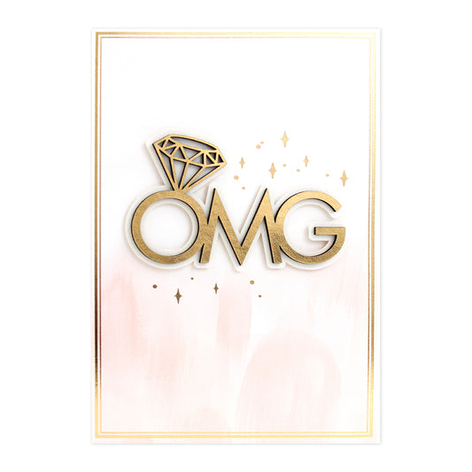 Hallmark Signature Engagement Congratulations Card - OMG featuring gold foil lettering, diamond illustration, and pink brushstroke background.