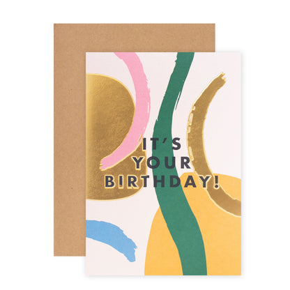 Halcyon by Hallmark Birthday Card – Abstract Shapes featuring vibrant designs with gold accents and natural kraft envelope, flat lay view.