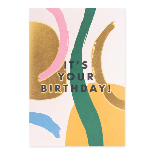 Halcyon by Hallmark Birthday Card – Abstract Shapes featuring vibrant gold, pink, and green shapes on textured stock in a flat lay presentation.