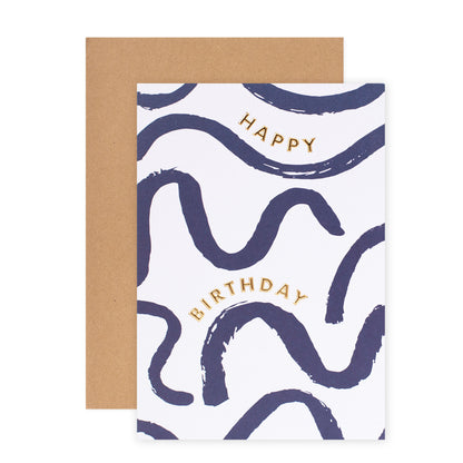 Halcyon by Hallmark Birthday Card – Navy Squiggles, premium textured card with gold lettering and wavy blue patterns, flat lay with kraft envelope.