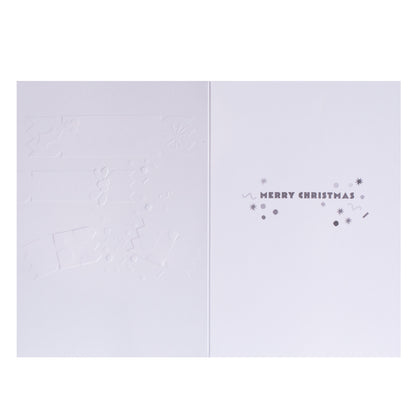 A minimalist white Christmas greeting card shown open, with embossed holiday motifs on the left panel and the right panel reading “MERRY CHRISTMAS” in small gray lettering with decorative dots and stars.