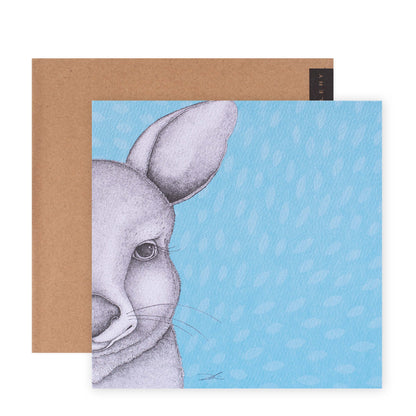 Hallmark x Dots by Donna Gallery Blank Greeting Card - Jasmine The Joey with a blue background and a close-up illustration of a joey's face.