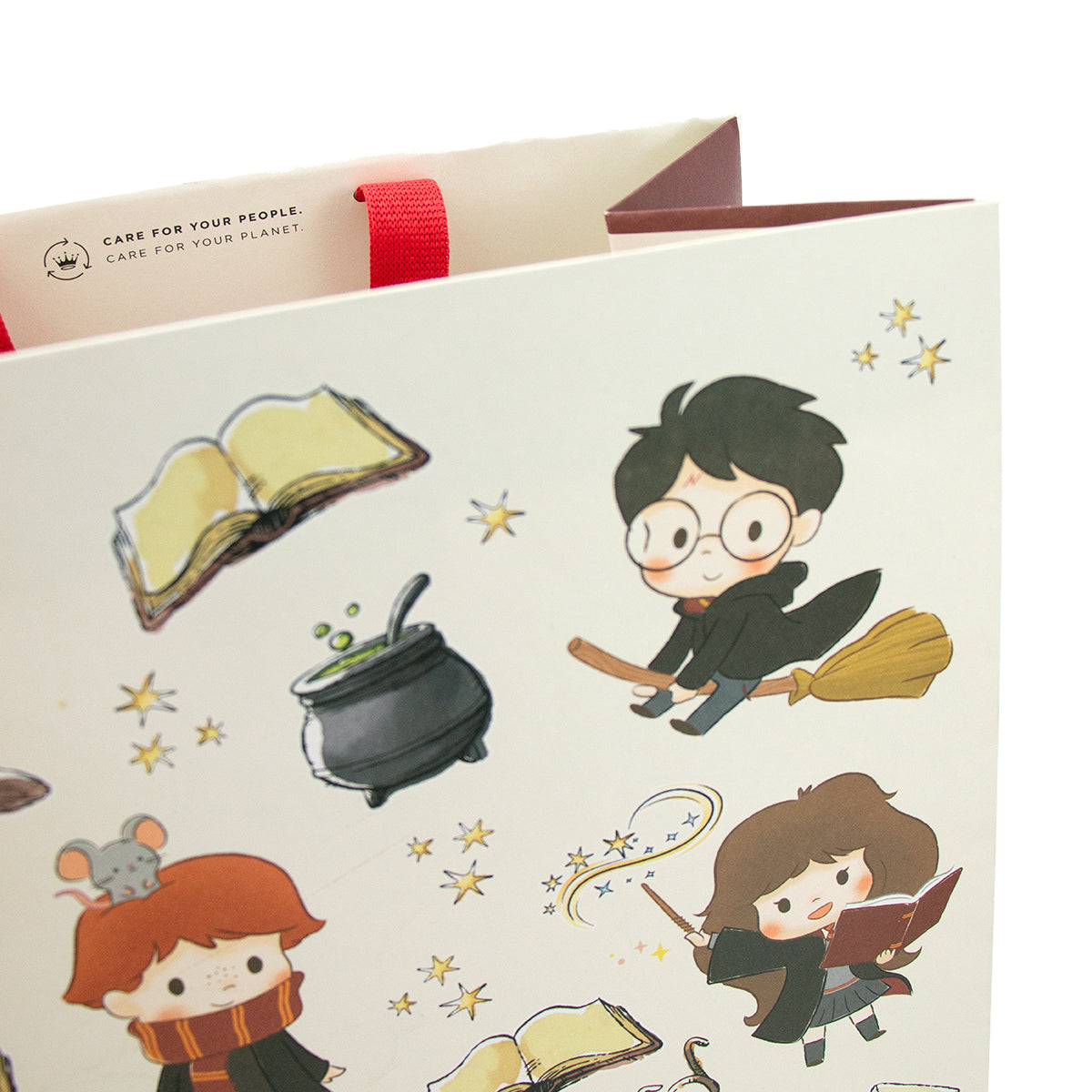 Harry Potter™ large gift bag featuring whimsical characters and magical elements, angled view displaying colourful designs.