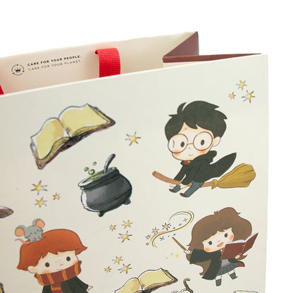 Harry Potter™ large gift bag featuring whimsical characters and magical elements, angled view displaying colourful designs.