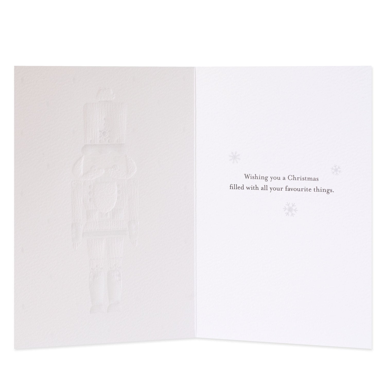 Hallmark Signature 8 Pack Boxed Charity Christmas Cards - Nutcracker, inside view, subtle embossed nutcracker design with text wishing a Merry Christmas.