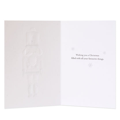 Hallmark Signature 8 Pack Boxed Charity Christmas Cards - Nutcracker, inside view, subtle embossed nutcracker design with text wishing a Merry Christmas.