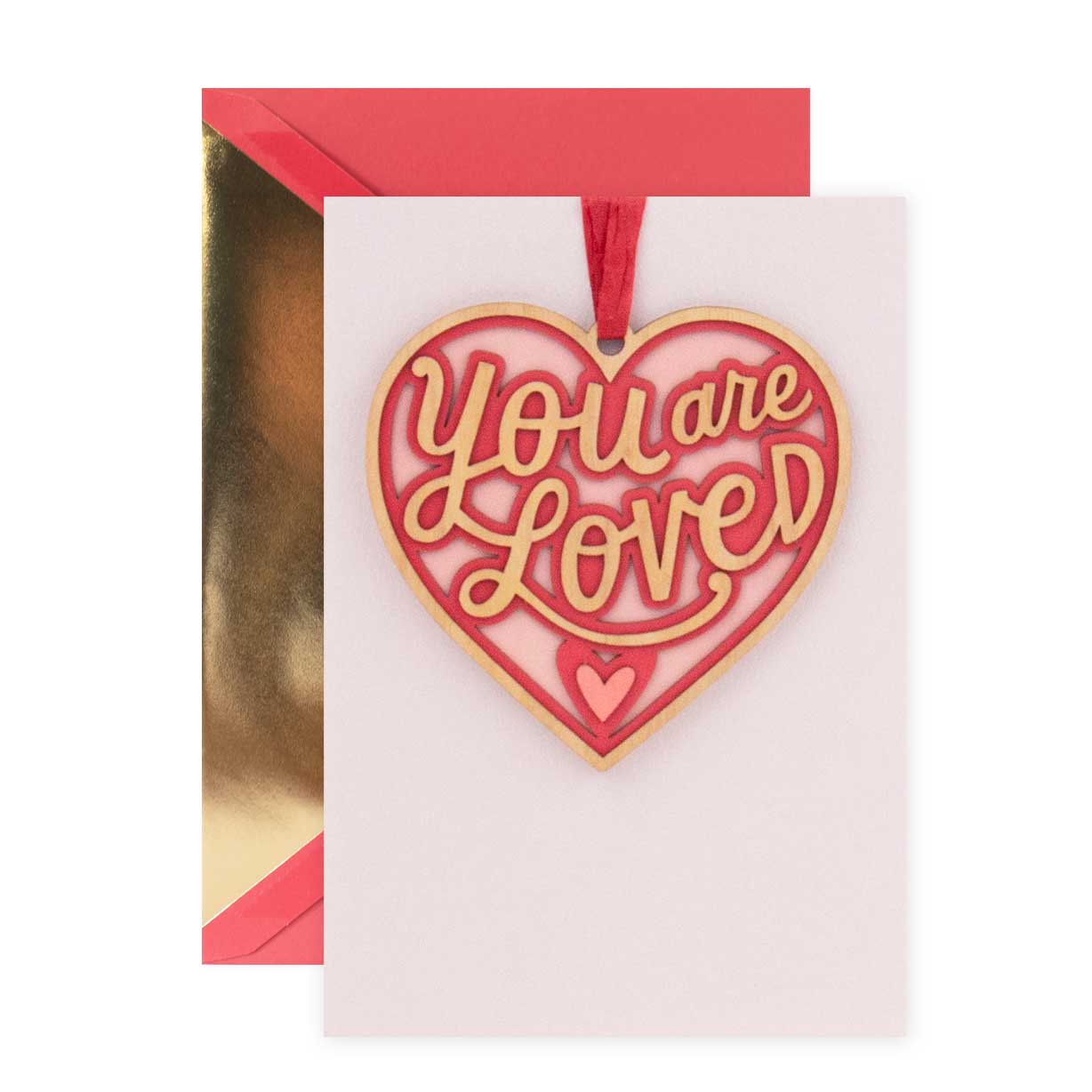 Hallmark Signature Valentine's Day Card - You Are Loved featuring a laser cut red heart ornament and gold foil highlights, flat lay view.