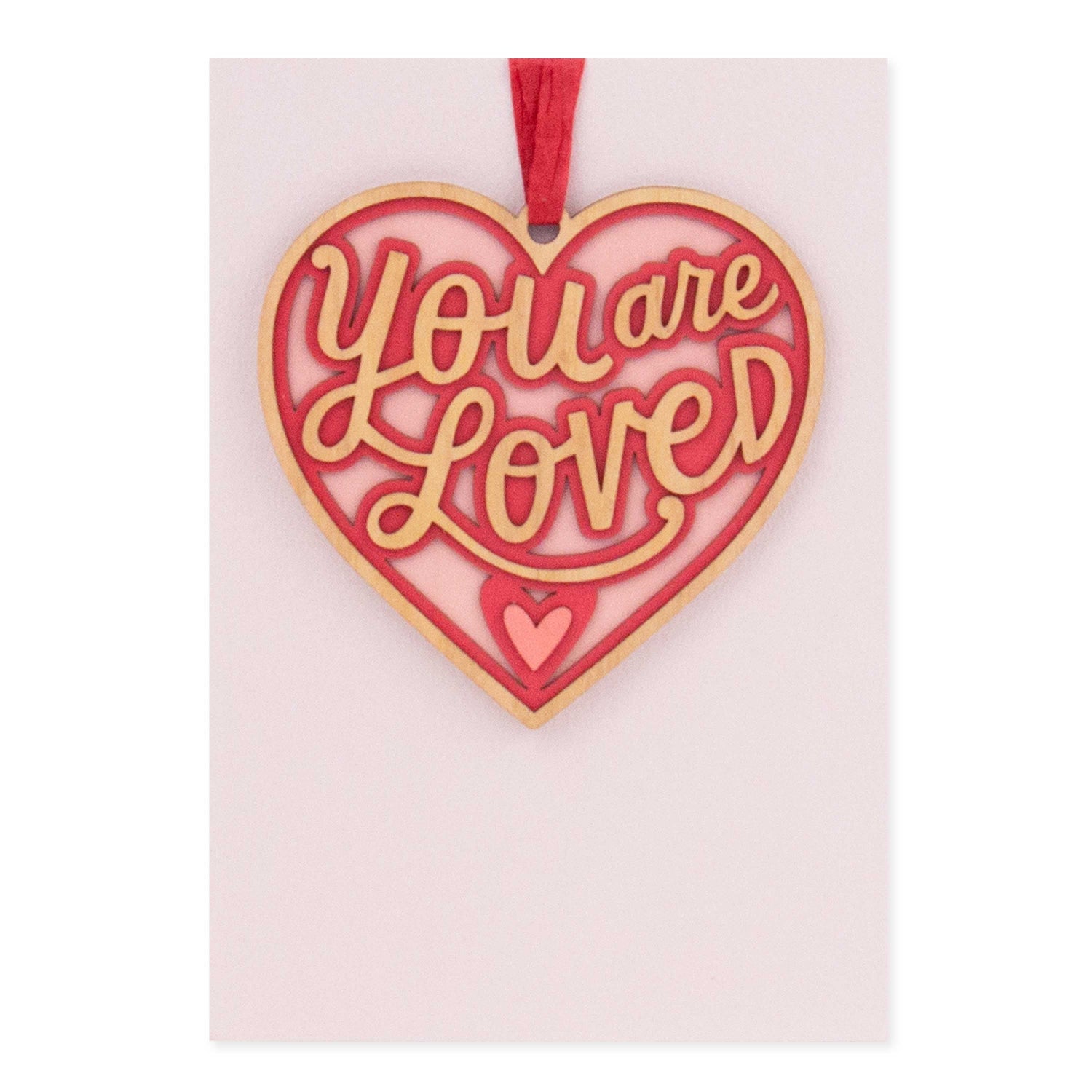 Hallmark Signature Valentine's Day Card - You Are Loved features a detachable heart ornament in red and gold with a pink background.
