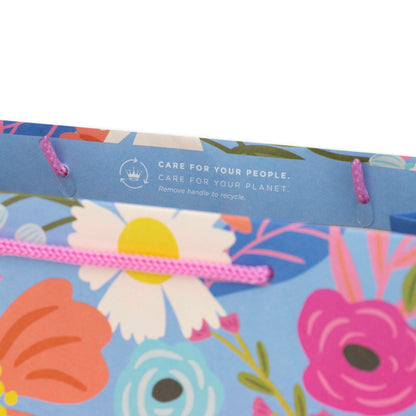 Hallmark Large Gift Bag - Christie Williams Floral featuring pink cord handles and colourful floral design, top view with care instructions.
