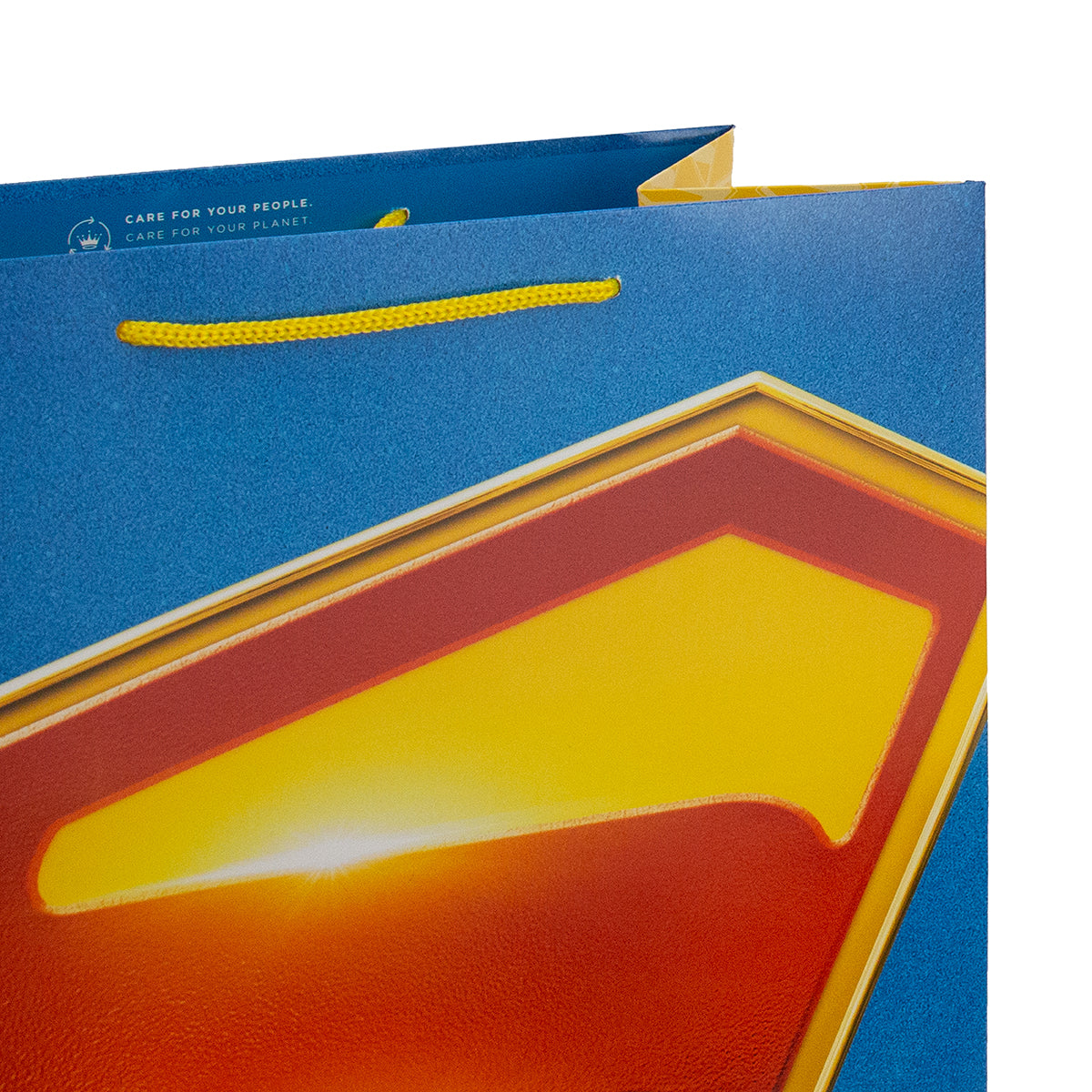 Hallmark Giftbag - Large Superman Shield in vibrant blue with yellow accents and a glossy finish, angled view showcasing details.
