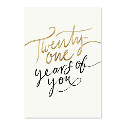 A vertical greeting card or print with an off-white background featuring the phrase 'Twenty-one years of you' in elegant script. The word 'Twenty-one' is written in metallic gold foil, while 'years of you' is in black cursive.