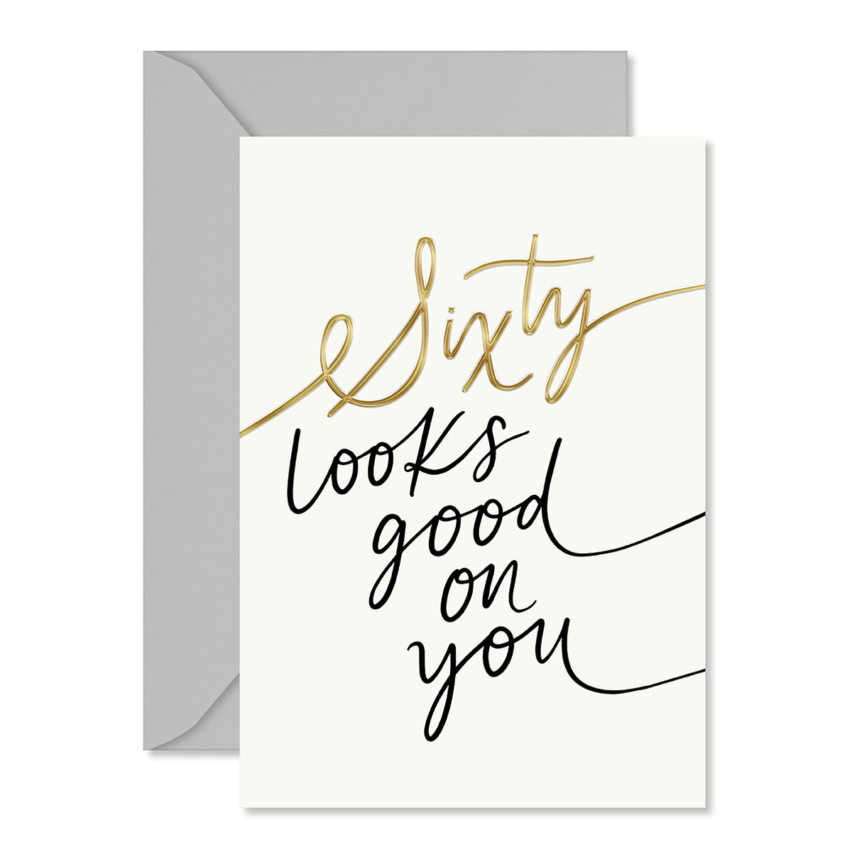 A greeting card with a light gray envelope behind it. The card has an off-white background with the phrase 'Sixty looks good on you' written in elegant black and metallic gold script.