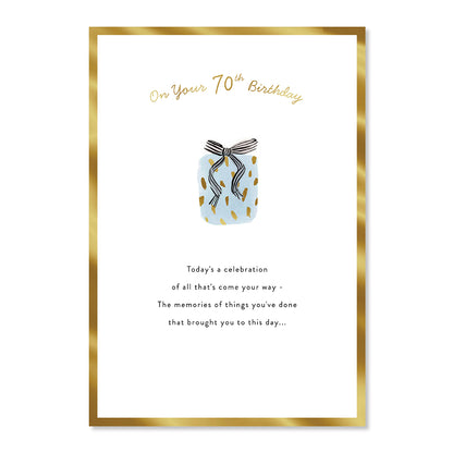 Hallmark 70th Birthday Card - Special Day features gold foil highlights, patterned gift illustration, and heartfelt message, flat lay view.