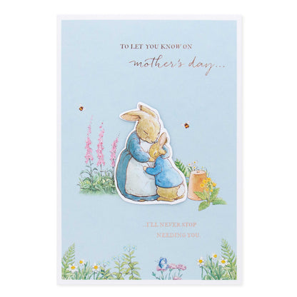 Hallmark Peter Rabbit Mother's Day card featuring Peter and Mrs Rabbit in a blooming garden, with rose gold foil highlights and 3D plaque.