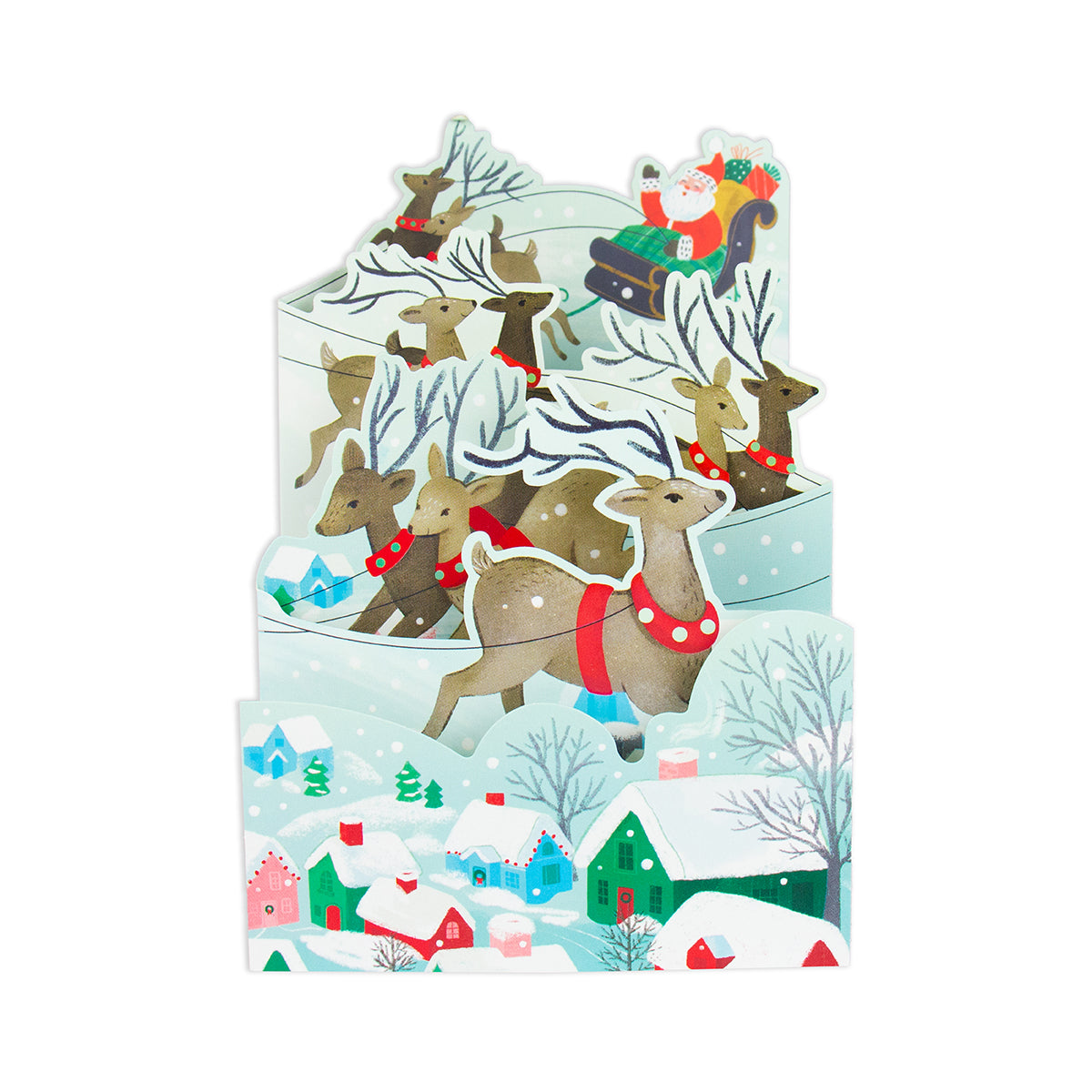 A 3D pop-up cardboard Christmas scene featuring Santa Claus in a sleigh with reindeer, set against a snowy winter village with colorful houses and trees.