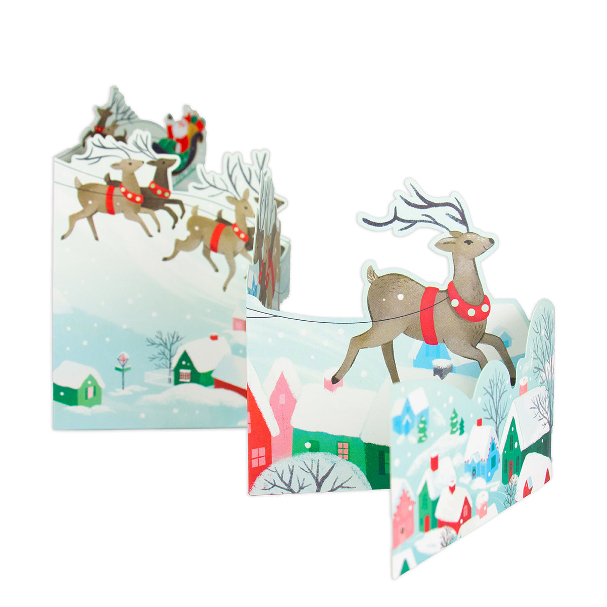 A set of 3D pop-up cardboard Christmas cards featuring festive winter scenes with reindeer, snow-covered houses, and Santa Claus, displayed against a solid white background.