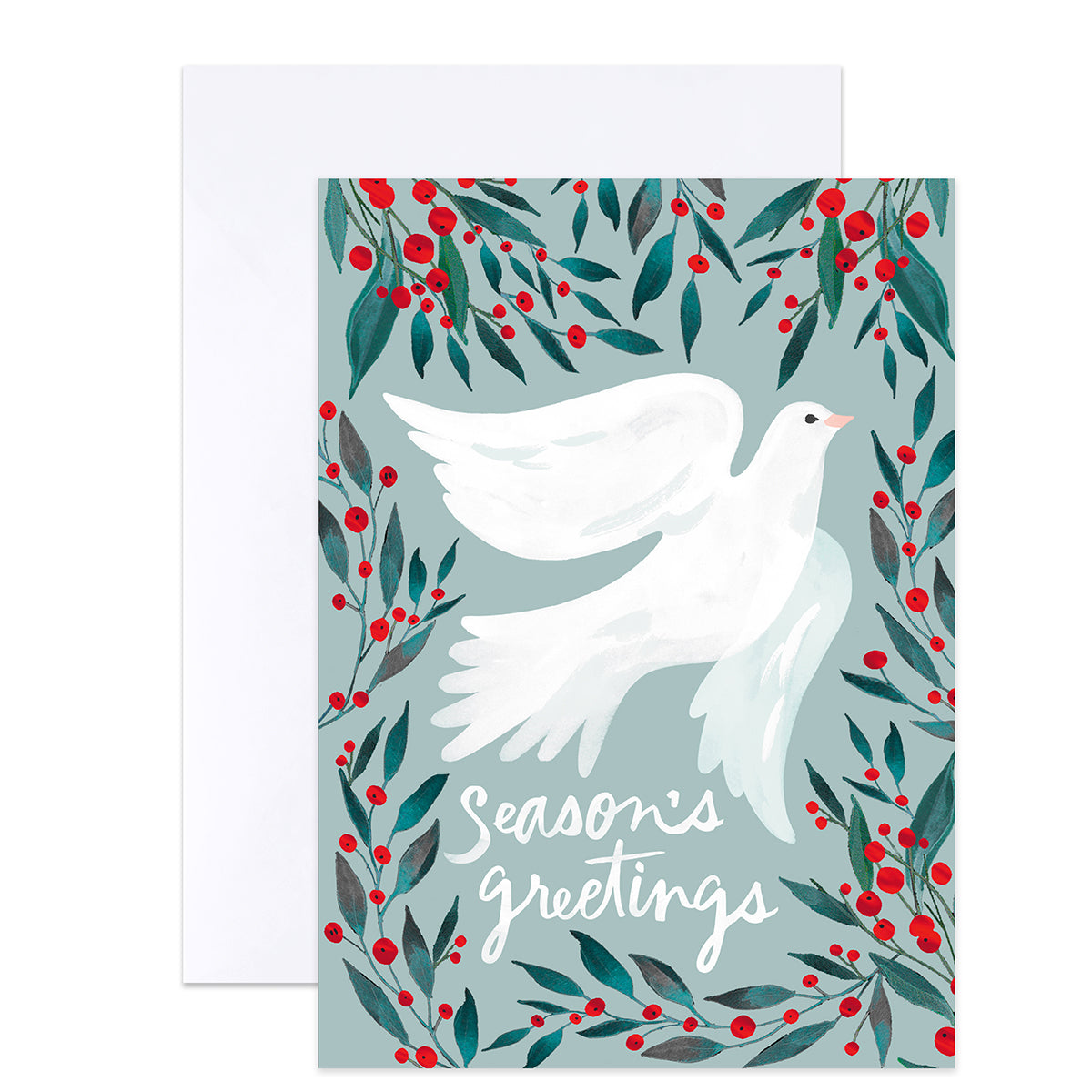 A greeting card with a white dove flying among green leaves and red berries on a pale blue background, with the words “Season’s greetings” in white script. A white envelope is placed behind the card.