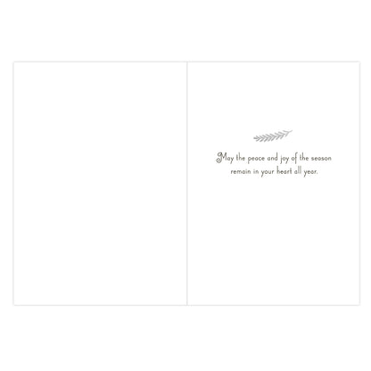 A blank greeting card shown from the back, with a small gray decorative sprig and the printed message, 'May the peace and joy of the season remain in your heart all year.' on a white background.