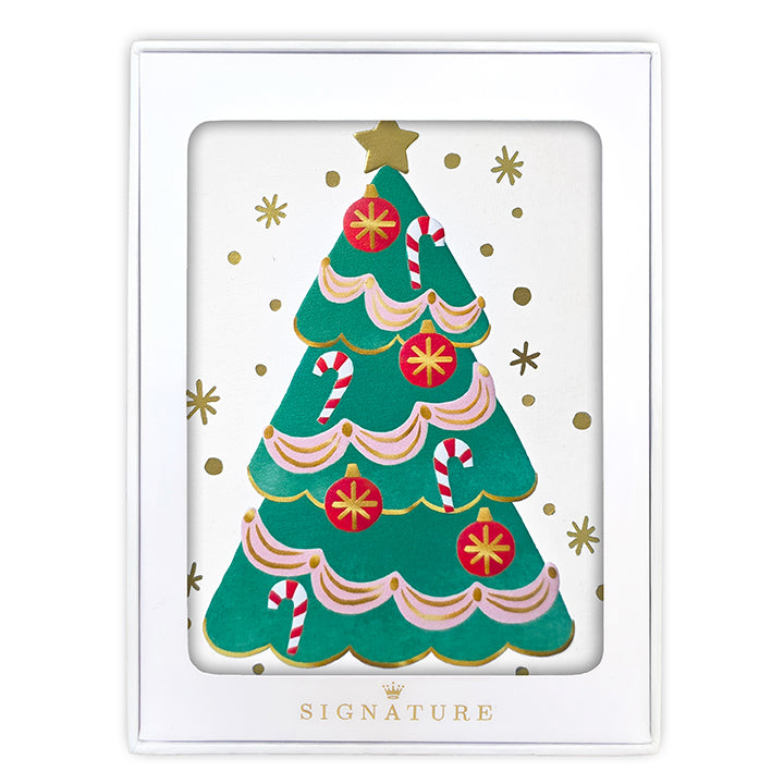 A white square gift box with a clear front window displaying a festive Christmas tree illustration. The tree is green with pink scalloped trim, red ornaments, candy canes, and gold stars and dots.