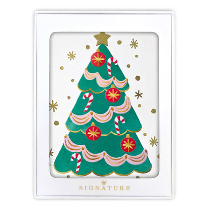 A white square gift box with a clear front window displaying a festive Christmas tree illustration. The tree is green with pink scalloped trim, red ornaments, candy canes, and gold stars and dots.