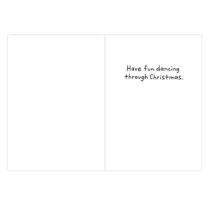 A blank greeting card or note with a folded-panel design. The right panel contains small black handwritten-style text reading, "Have fun dancing through Christmas.