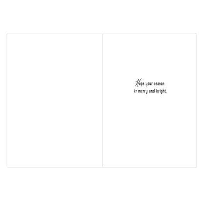 A blank greeting card shown from the inside, with a small black script phrase reading 'Hope your season is merry and bright.' on the right side against a white background.