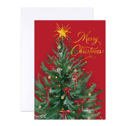 A Christmas greeting card with a red background, decorated green tree illustration, gold star and script text reading 'Merry Christmas,' shown with a white envelope behind it.