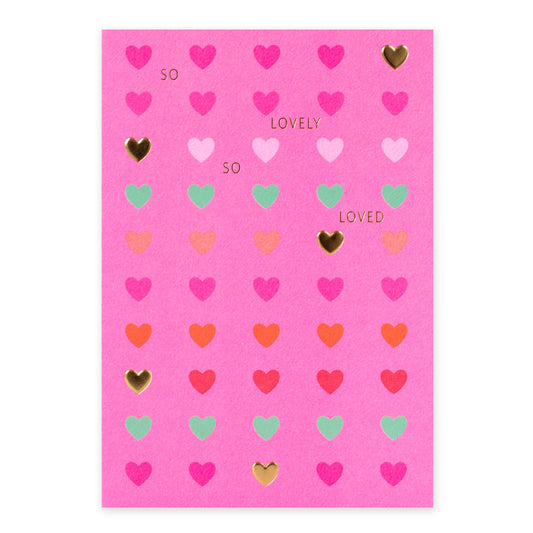 Hallmark Blank Card - So lovely, so loved, bright pink with embossed hearts and gold foil detailing, flat lay view.