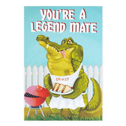 Hallmark Ozzy Oddities Greeting Card - Crikey Croc featuring a crocodile in an apron holding a plate, BBQ scene, colourful illustration.