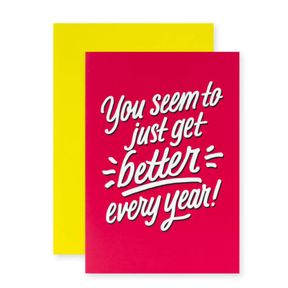 Hallmark Shoebox Birthday Card - Better Every Year in pink and white with a yellow envelope, featuring the message on the front.