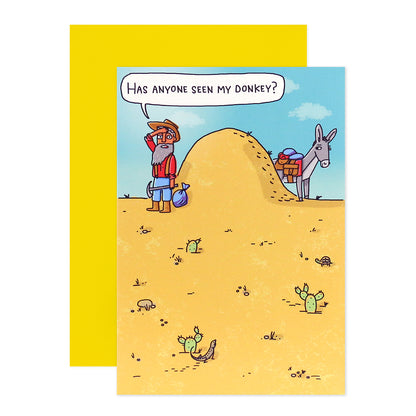 Hallmark Shoebox Birthday Card - Over The Hill with cartoon man and donkey illustration, featuring a humorous desert scene and bright yellow envelope.