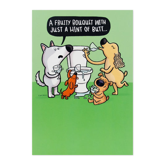 Hallmark Shoebox Birthday Card - Toilet Water featuring cartoon dogs drinking toilet water with humorous text, flat lay view.