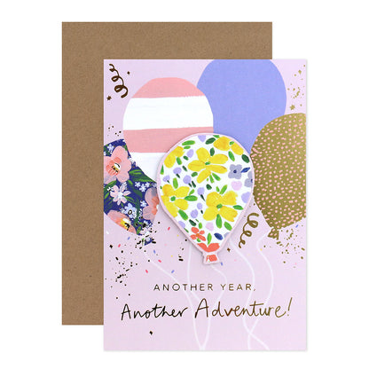 Connections from Hallmark Birthday Card - Another Year, Another Adventure with patterned balloons and gold foil highlights in a flat lay view.