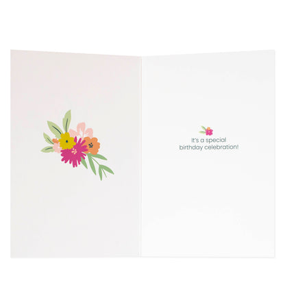 16th birthday fem card with floral design, featuring a heartfelt message inside, displayed open on a flat surface.