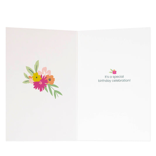 16th birthday fem card with floral design, featuring a heartfelt message inside, displayed open on a flat surface.