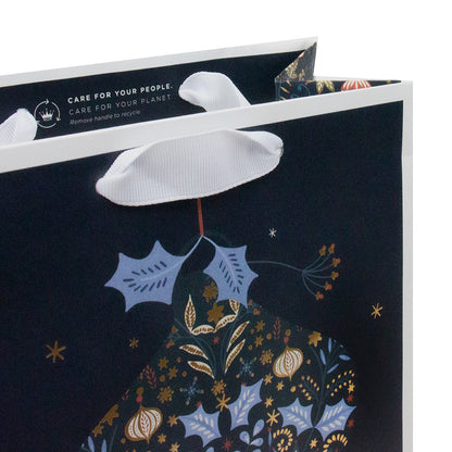 Hallmark Medium Gift Bag - All Is Bright, All Is Calm with white grosgrain handles and floral bauble design, close up view.