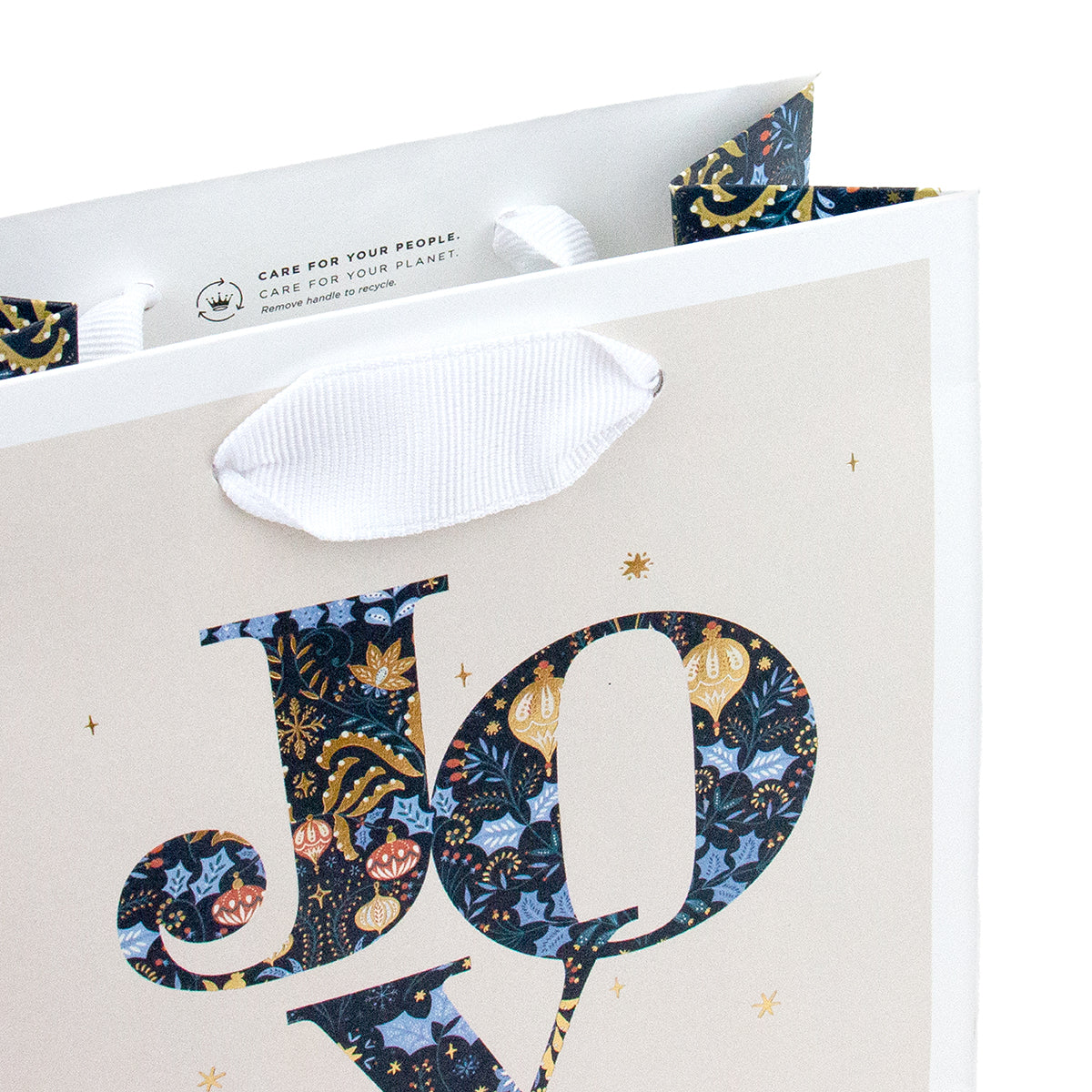 Hallmark Small Gift Bag - JOY featuring a detailed floral and bauble design with white grosgrain ribbon handles in an angled view.