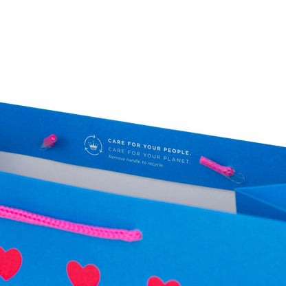 Hallmark Medium Gift Bag - Neon Hearts with bright blue background and hot pink cord handles showcasing recycling instructions.
