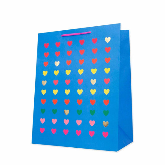 Hallmark Large Gift Bag - Neon Hearts in bright blue featuring colourful hearts with gold foil highlights, angled view.