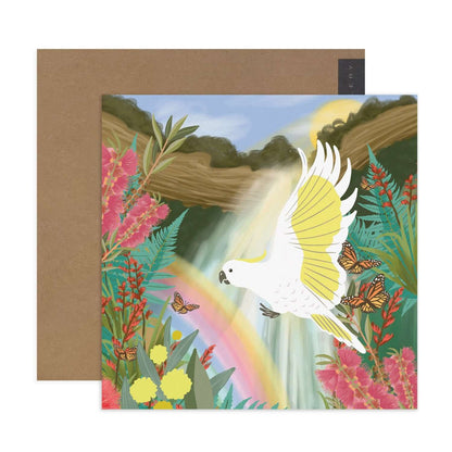 Hallmark x Christie Williams Gallery Blank Greeting Card - Waterfall featuring a vibrant illustration of a flying white cockatoo and blooming flora.