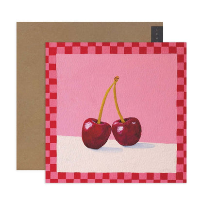 Hallmark x Kayla Henley Gallery Blank Greeting Card - Cherries On Top featuring vibrant cherries on a pink background with checkered border and kraft envelope