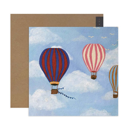 Hallmark x Kayla Henley Gallery Blank Greeting Card - High In The Sky featuring hot air balloons against a blue sky background, flat lay view.