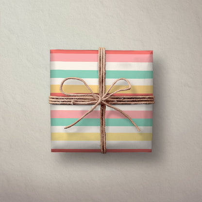 Hallmark Flat Wrapping Paper - Pastel Stripes used to wrap a gift, featuring pastel pink, yellow, green, and white stripes with twine.