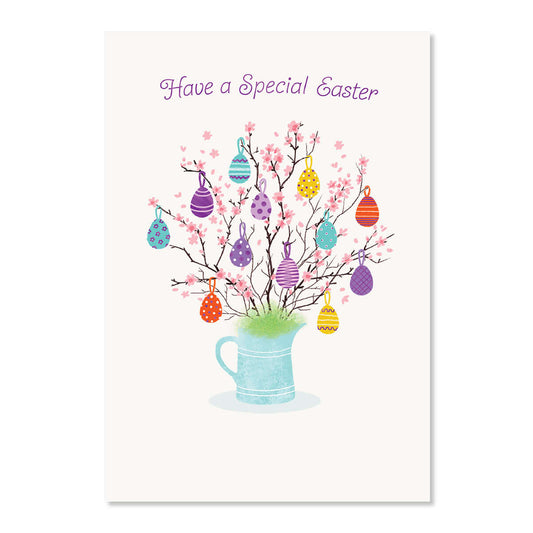 Easter card with colorful eggs on a tree branch in a mug, against a white background.
