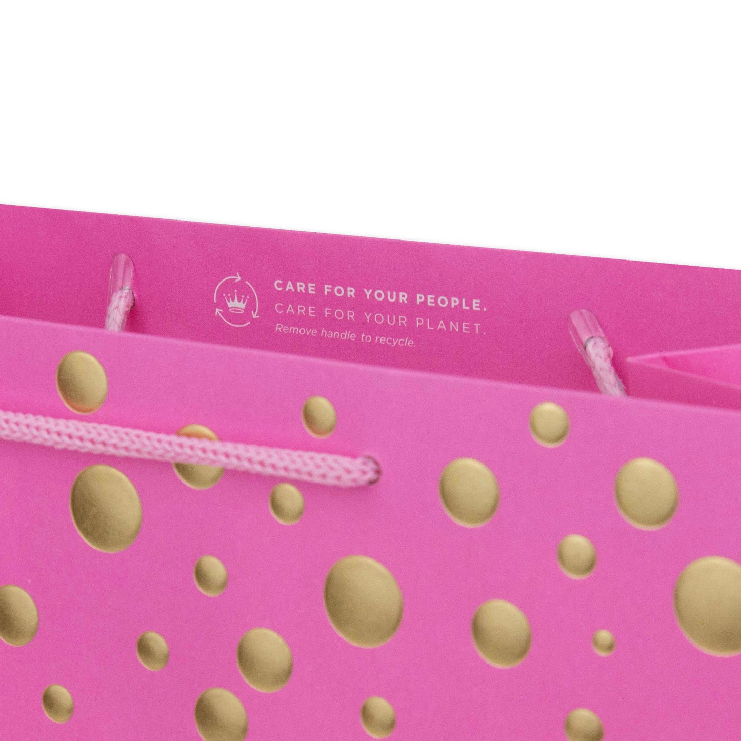 Hallmark Large Gift Bag - Gold Bubbles, close up of pink bag with gold dots and recycling instructions, features cord handles.