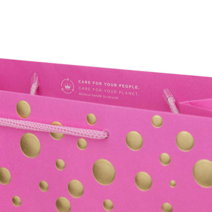 Hallmark Large Gift Bag - Gold Bubbles, close up of pink bag with gold dots and recycling instructions, features cord handles.