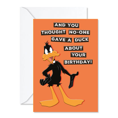 Hallmark Looney Tunes™ Birthday Greeting Card - Daffy Duck featuring an orange background and humorous text about birthdays, with a white envelope.
