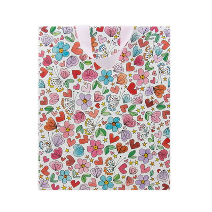 Hallmark x Love, Meredith Large Gift Bag - Butterflies, Hearts, Stars & Flowers with colourful floral and heart illustrations in a light pink design.
